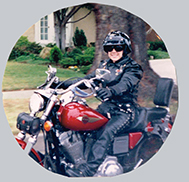 Sandy, the company owner riding her first Red Sportster Harley Davidson Motorcycle